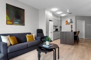 a living room with a couch and a table at Tower Apartments in Reykjavík