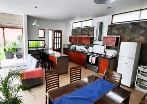 a kitchen and living room with a couch and a table at KUSI WASI CIENEGUILLA in Cieneguilla