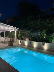 a swimming pool in a backyard at night at HOTEL MERCURIO SUL MARE - Fish restaurant and private beach in Capo Vaticano