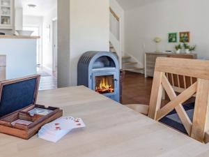 a table with a fireplace in a living room at 6 person holiday home in Bl vand in Blåvand