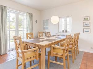 a dining room with a table and chairs at 6 person holiday home in Bl vand in Blåvand