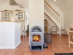 a fireplace in the middle of a living room at 6 person holiday home in Bl vand in Blåvand