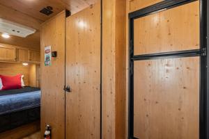 a wooden door in a room with a bed at JT Village Campground - Sun Ray in Joshua Tree