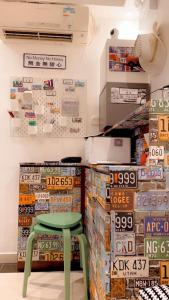 a green stool in a store with boxes of cereal at The Cultural Crashpad - 康乃馨旅館 in Hong Kong