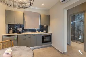 a kitchen with a table and a counter top at Villa Dimitra - Saint Nikolas Retreat in Faraklata