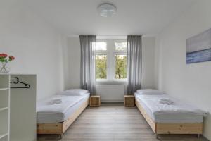Habitación con 2 camas y ventana en T&K Apartments - 1-3 Zimmer Apartments - Essen, en Essen