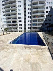 a swimming pool in front of some tall buildings at Exclusivo apto / norte de valledupar hasta para 12 in Valledupar