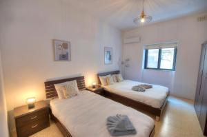 1 dormitorio con 2 camas y ventana en Enormous 3bedrooms seafront with balcony PDEH1-1 en Sliema