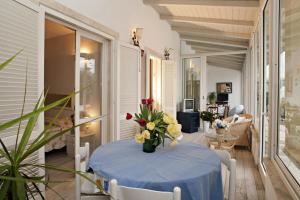 a table with a blue table cloth and flowers on it at TERESITA WELLNESS CLUB in Viareggio