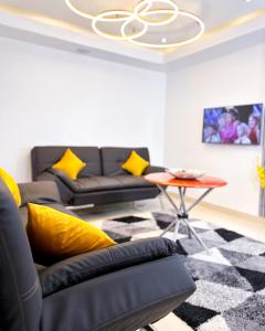 a living room with a couch and a table at The Gibs Hotel Limited in Port Harcourt