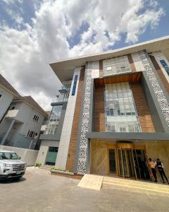 a building with people standing outside of it at The Gibs Hotel Limited in Port Harcourt