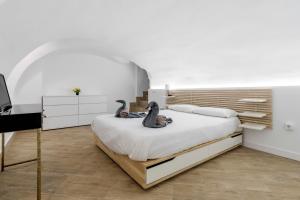 a bedroom with two stuffed animals sitting on a bed at El triangulo del Arte - Jacuzzi in Madrid
