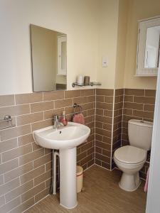 a bathroom with a sink and a toilet at Whitebeam in Camber