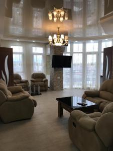 a living room with a fireplace and a chandelier at Apartment near the seaside in Batumi