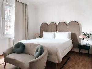 a bedroom with a large bed and a couch at Villa Maldestra in Rimini