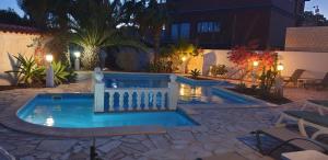a swimming pool in a backyard at night at Villa Océano with private heated pool, aircon and Seaview in Parque Holandes +38 photos