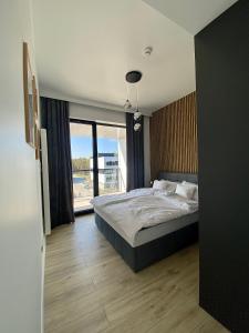 a bedroom with a bed and a large window at Rogowo Prestige Shellter in Rogowo