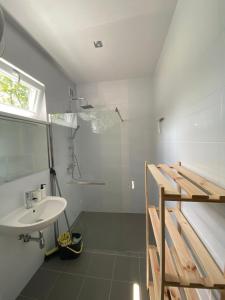 a bathroom with a sink and a shower at Apartamenty Na Wschodniej in Chłopy