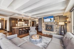 a living room with a couch and a fireplace at Spacious Luxury Unit at Lionshead Village in Vail in Vail