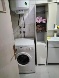 een wasmachine in een badkamer met een wastafel bij Şişli Özcan 1 in Istanbul