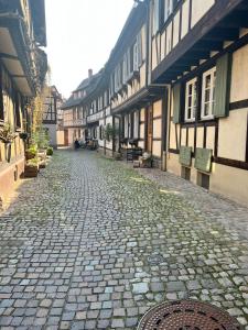 a cobblestone street in a town with buildings at Black Forest Apartments in Gengenbach