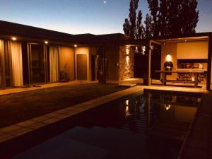 a house with a swimming pool at night at Maynumbí in San Rafael