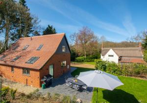 an overhead view of a house with an umbrella at Peaty Cottage in Panxworth