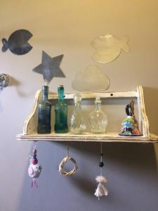 a shelf with glass bottles on a wall at Maynumbí in San Rafael