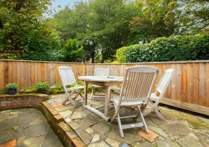 a table and chairs sitting on a patio at Reading Room Cottage in Overstrand