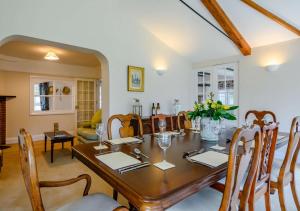 a dining room with a wooden table and chairs at Rose Cottage - West Runton in West Runton