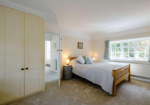 a bedroom with a large bed and a window at Rose Cottage - West Runton in West Runton