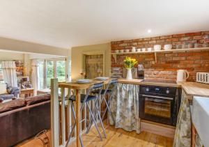 a kitchen with a counter and a brick wall at Rose Lodge in Yaxham