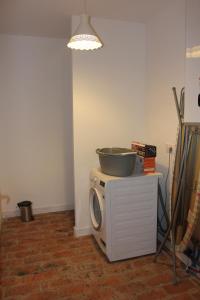 a kitchen with a bowl on top of a microwave at Gîte de charme pour 10 personnes in Camélas