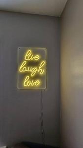 a sign on a wall that says live laugh love at Beautiful 'n' Cosy - City Center in Etruria