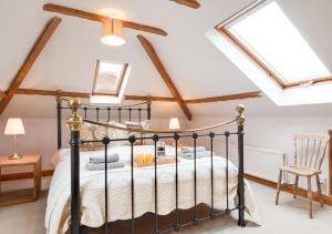 a bedroom with a black bed with skylights at Smugglers Retreat in Wells next the Sea