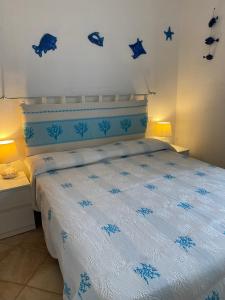 a bedroom with a blue and white bed with stars on the wall at Casa Antonella in Santa Teresa Gallura