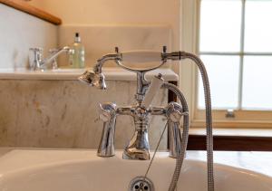 a bathroom sink with a silver faucet at St Lawrence House 