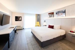 a bedroom with a bed and a desk and a television at Gateway Hotel and Conference Center in Ames