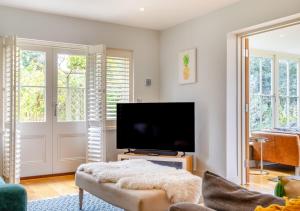 a living room with a flat screen tv and a couch at South Way in West Runton