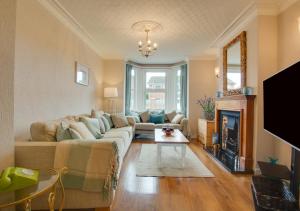a living room with a couch and a fireplace at Staithe Cottage in Heacham