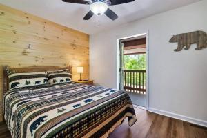 a bedroom with a bed and a ceiling fan at Cozy Getaway in Pigeon Forge