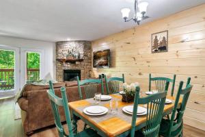a dining room with a table and chairs and a couch at Cozy Getaway in Pigeon Forge