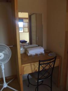 a room with a table and a chair and a mirror at Casa Campo Rancho Villarino in Ensenada