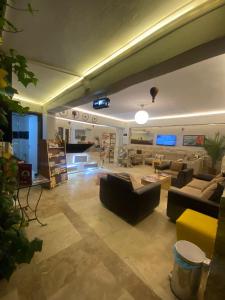 una gran sala de estar con sofás y TV. en OzenTurku Hotel, en Pamukkale