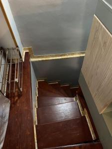 a staircase in a house with wooden floors at Wooden interior in village krini. in Corfu Town