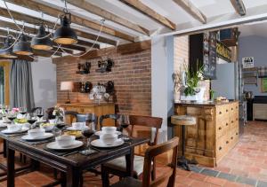a dining room with a table and chairs and a brick wall at The Granary 