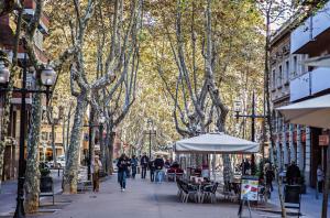 a city street with people walking down the street at Sweet Inn - Loft Villa Olimpica Beach in Barcelona