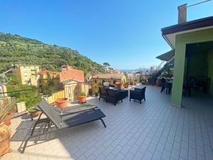 a patio with chairs and tables on a balcony at LA TERRAZZA DI MONTEROSSO in Monterosso al Mare