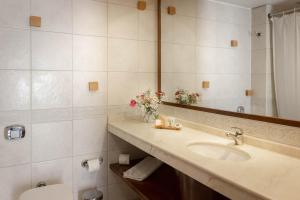 a bathroom with a sink and a mirror at Hotel Fundador in Santiago