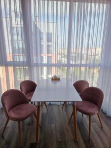 ルツカイにあるDream Town,залізничний вокзалの大きな窓の前にテーブルと椅子4脚